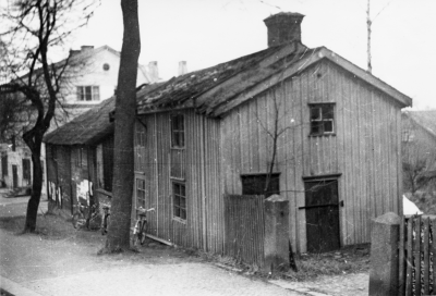 Järnvägsgatan, Enells på Vinketomta ägde denna fastighet, på gatan mot  Stationsallén. Vimmerby Tidning finnes där idag. På gården fanns stall för bönderna, om de kom till Vimmerby. I detta grå hus bodde Ture Linds farfar, på nedre botten. På övre våningen bodde en tant, som hette Klara efternamn okänt.