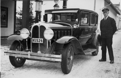 Bilden är tagen utanför Leanders Gummiverkstad i början av 1930 - talet. Chaufför Torvald Eriksson. Ägare till bilen var Johan Adolfsson. Bilen var en Oakland